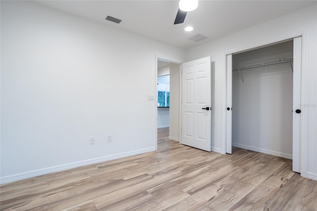 unfurnished bedroom with ceiling fan, a closet, and light hardwood / wood-style floors