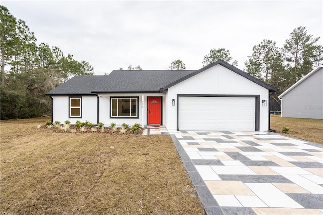 single story home featuring a garage and a front lawn