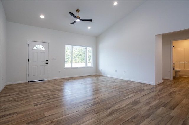 interior space featuring high vaulted ceiling, hardwood / wood-style floors, and ceiling fan