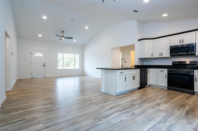 kitchen featuring kitchen peninsula, black appliances, and light hardwood / wood-style flooring