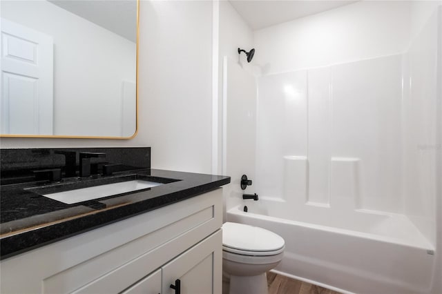 full bathroom with tub / shower combination, vanity, toilet, and wood-type flooring