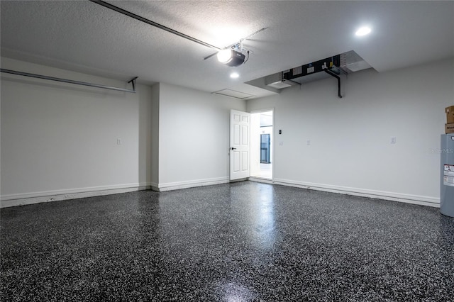 garage with a garage door opener and water heater