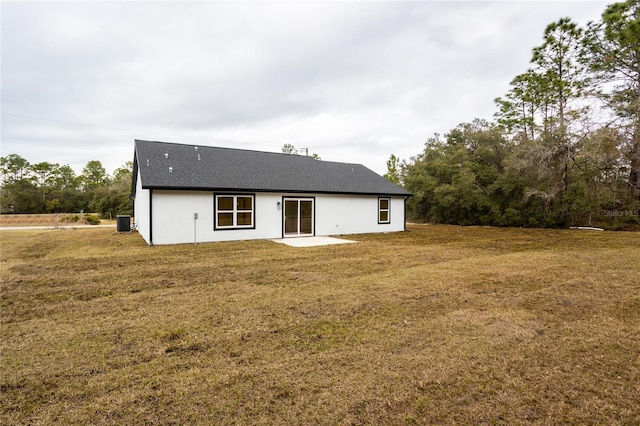 back of property with a patio area, a lawn, and central AC unit