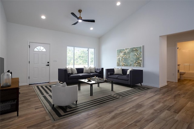 living room with high vaulted ceiling, ceiling fan, and wood-type flooring