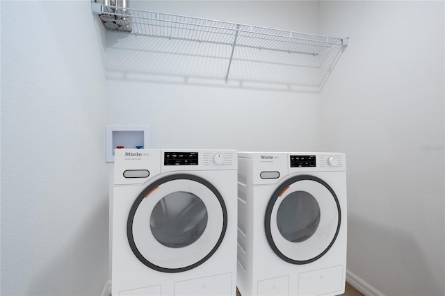 washroom featuring washer and clothes dryer