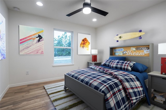 bedroom featuring a ceiling fan, baseboards, wood finished floors, and recessed lighting