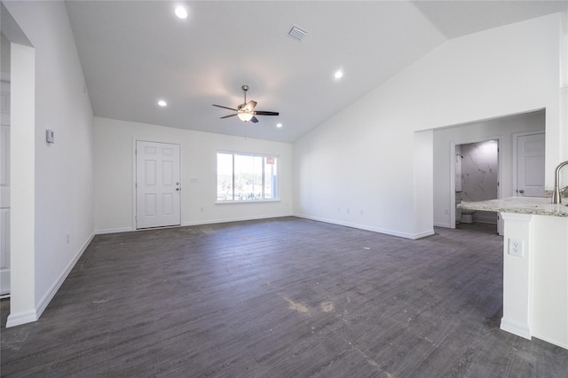 unfurnished living room with baseboards, visible vents, a ceiling fan, lofted ceiling, and dark wood-style flooring