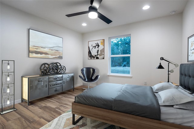 bedroom featuring ceiling fan, baseboards, wood finished floors, and recessed lighting