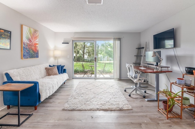 office featuring hardwood / wood-style flooring and a textured ceiling