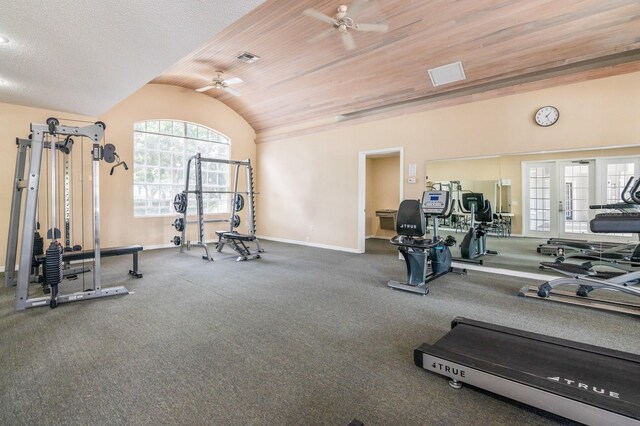 exercise room with baseboards, visible vents, a ceiling fan, and lofted ceiling