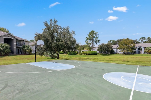 view of basketball court with a yard