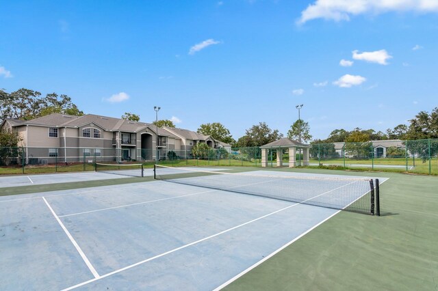 view of sport court featuring fence