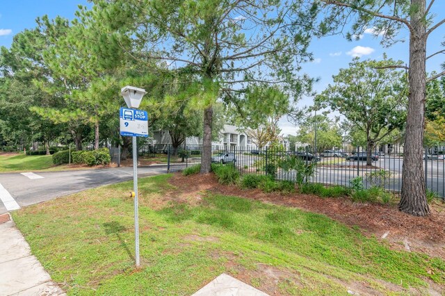 view of yard with fence and aphalt driveway