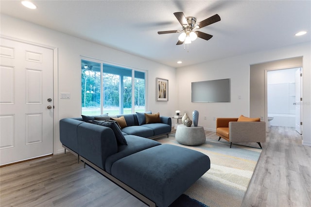 living room featuring ceiling fan and hardwood / wood-style floors