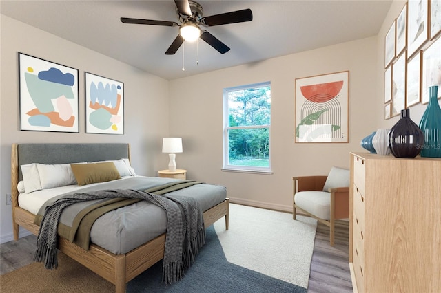 bedroom with ceiling fan and hardwood / wood-style floors