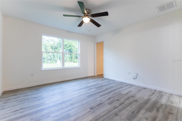 spare room featuring ceiling fan and light hardwood / wood-style floors