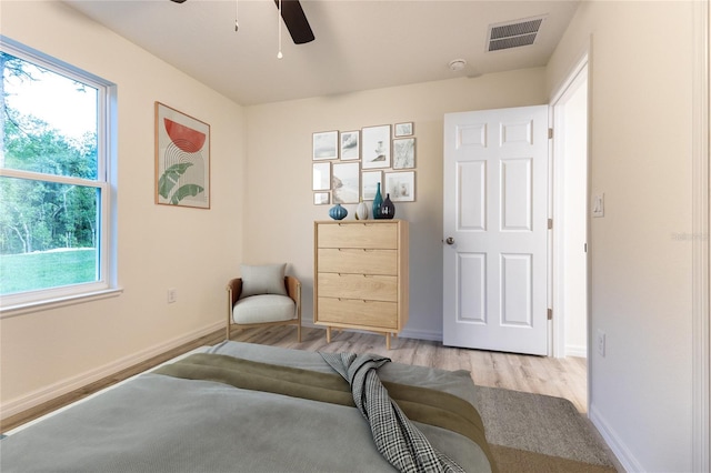 living area with ceiling fan and light hardwood / wood-style floors