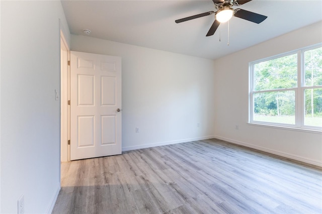 empty room with light hardwood / wood-style floors and ceiling fan