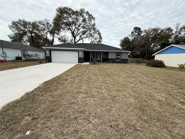 single story home featuring a front lawn and a garage