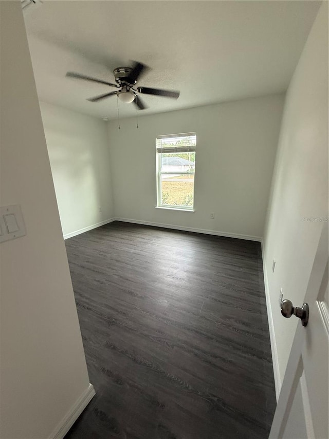 spare room featuring ceiling fan and dark hardwood / wood-style flooring