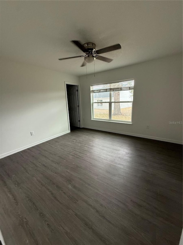 unfurnished room featuring ceiling fan and dark hardwood / wood-style floors