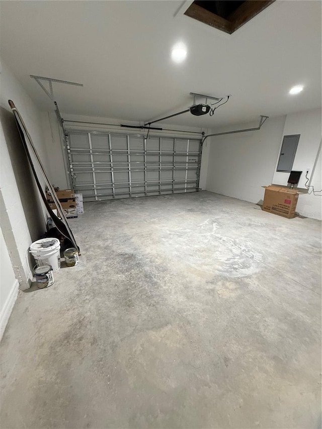 garage with electric panel and a garage door opener