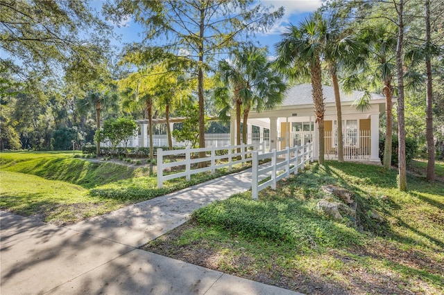 view of property's community with a lawn