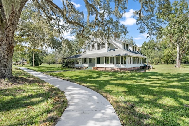 farmhouse inspired home featuring a porch and a front yard