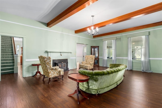 living room with a notable chandelier, beam ceiling, and dark wood-type flooring