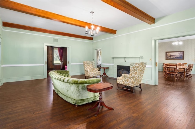 living room with dark hardwood / wood-style floors, beamed ceiling, and a notable chandelier