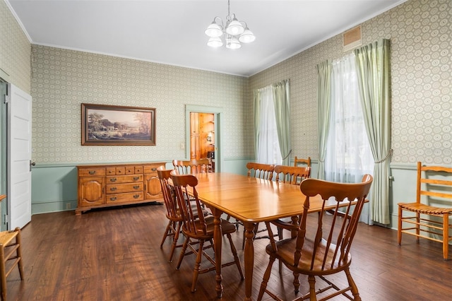 26502 NW 3rd Ave, Newberry, FL 32669 - dining area with dark wood finished floors, wallpapered walls, an inviting chandelier, crown molding, and wainscoting