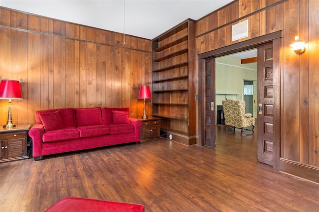 living room featuring wooden walls and dark wood-type flooring