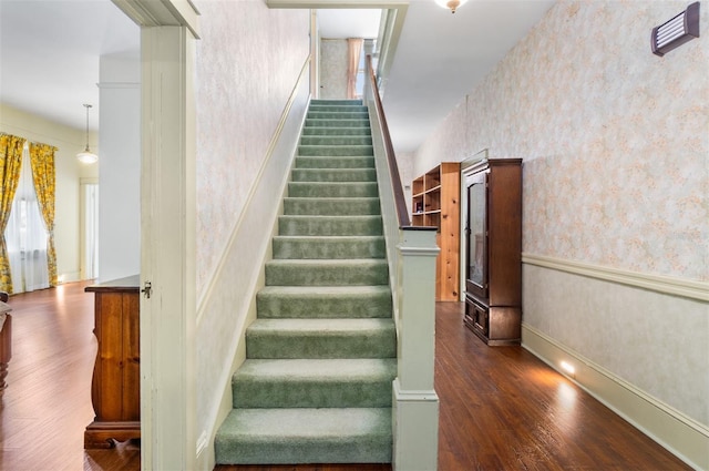 26502 NW 3rd Ave, Newberry, FL 32669 - staircase featuring wallpapered walls, wood finished floors, and baseboards