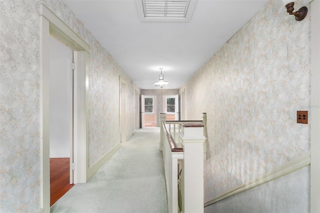 26502 NW 3rd Ave, Newberry, FL 32669 - corridor featuring wallpapered walls, visible vents, carpet, and an upstairs landing