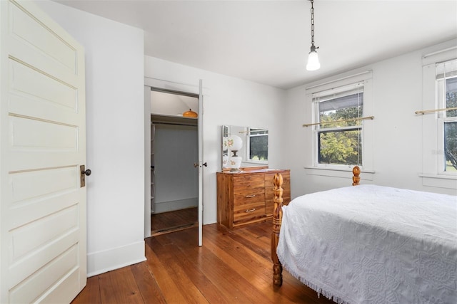 bedroom with a closet and dark hardwood / wood-style flooring