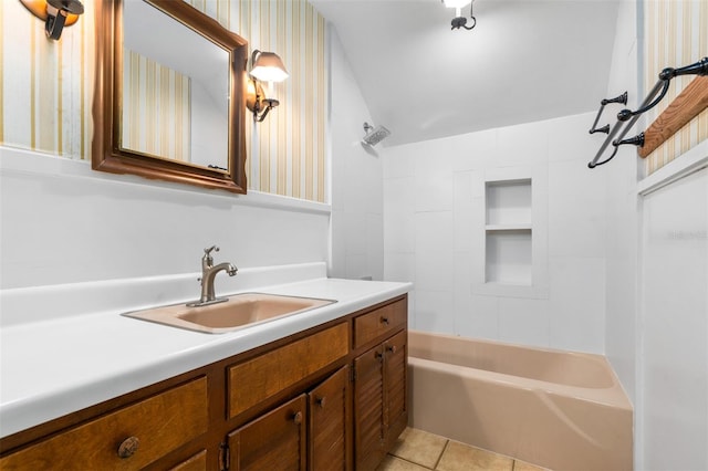 bathroom featuring tile patterned flooring, bathtub / shower combination, and vanity