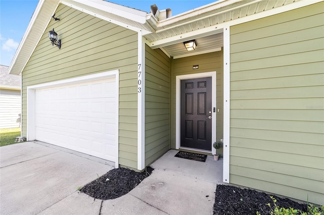 view of exterior entry with a garage