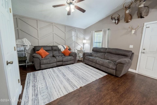 living room with ceiling fan, vaulted ceiling, and dark hardwood / wood-style floors