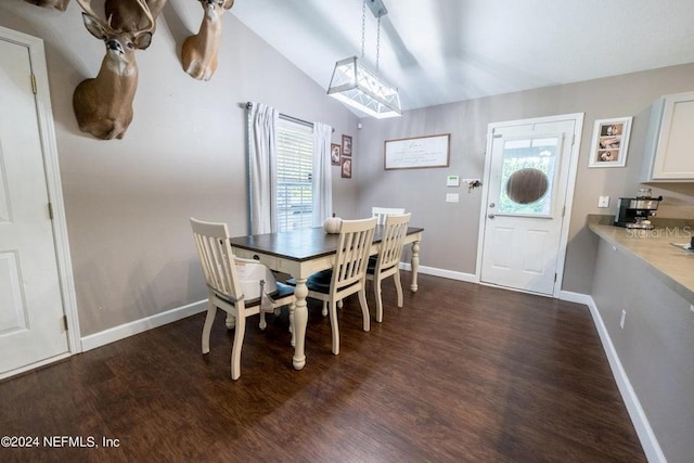 dining room featuring lofted ceiling, dark hardwood / wood-style flooring, and a wealth of natural light