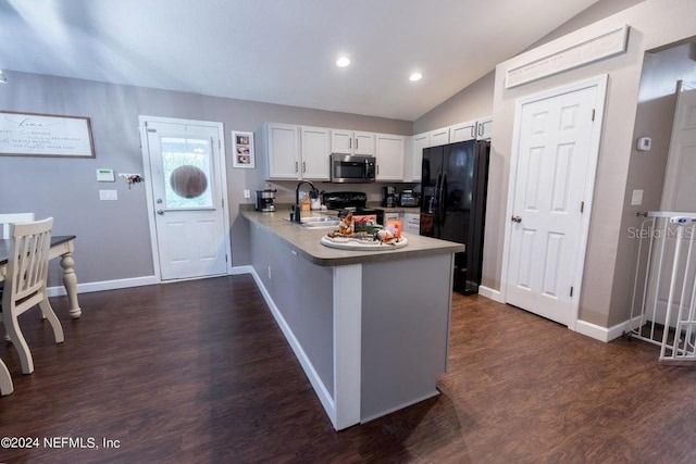 kitchen featuring lofted ceiling, black appliances, sink, kitchen peninsula, and white cabinetry