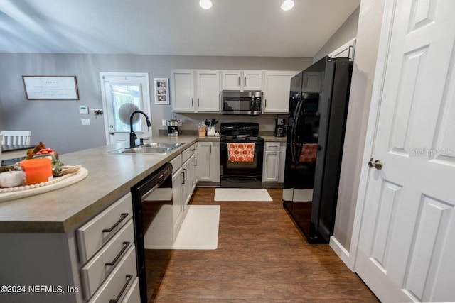 kitchen featuring black appliances, white cabinets, dark wood-type flooring, sink, and kitchen peninsula