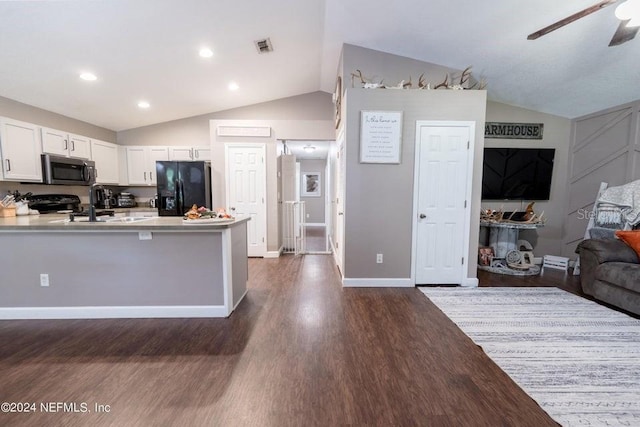 kitchen featuring dark wood-type flooring, vaulted ceiling, kitchen peninsula, white cabinets, and black appliances