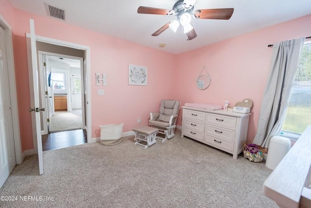 sitting room featuring ceiling fan and light carpet