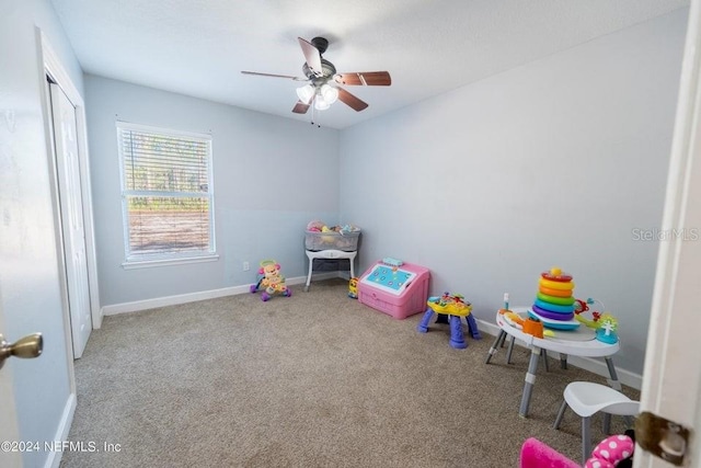 recreation room with ceiling fan and carpet flooring