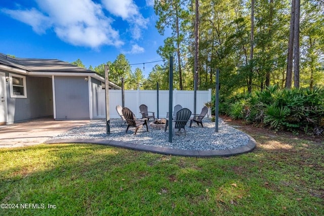 view of yard with an outdoor fire pit and a patio area