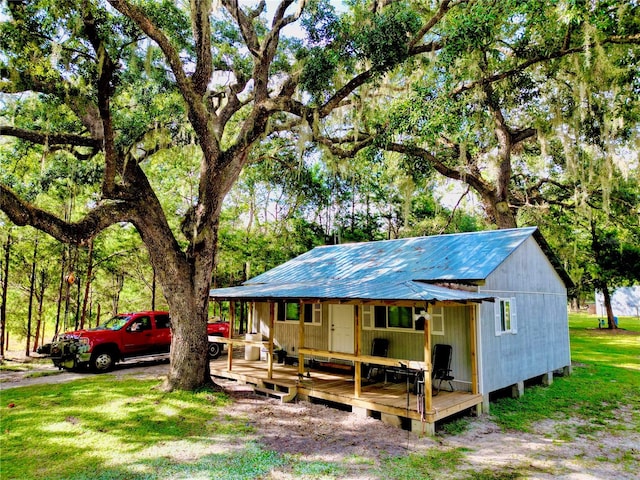 exterior space featuring a front lawn and a wooden deck