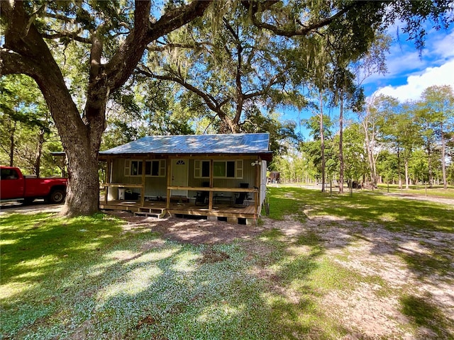 rear view of property with a yard