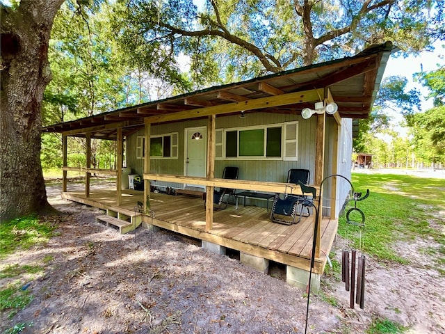 exterior space featuring a deck and a lawn