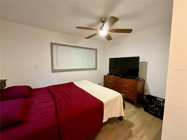 bedroom with ceiling fan and light hardwood / wood-style floors