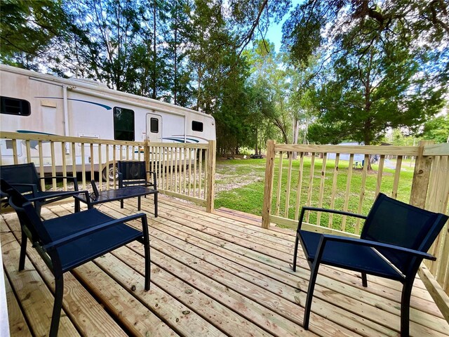 wooden deck with a lawn